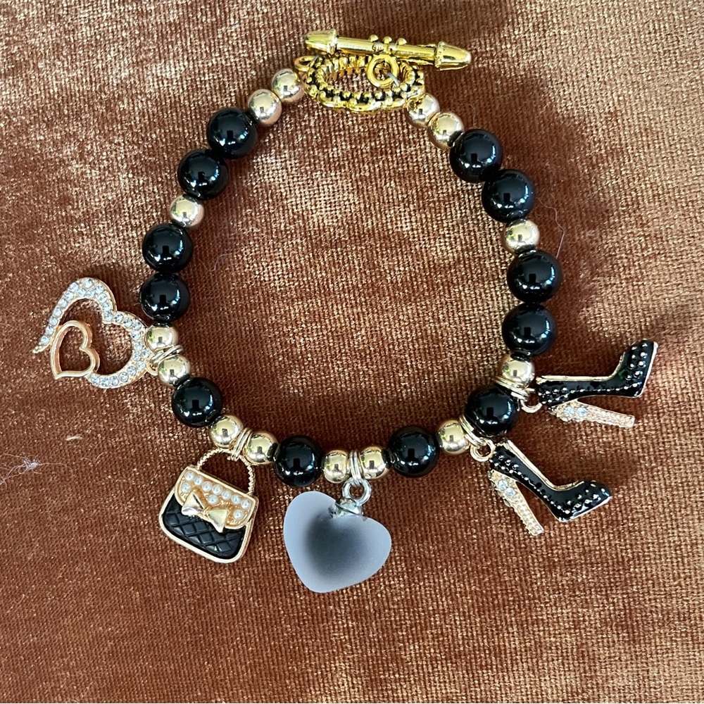 New handcrafted shopping themed bracelet combines blackbeads & goldaccents